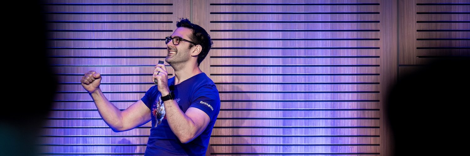 Me on stage giving a talk, fist pumping and looking really happy.